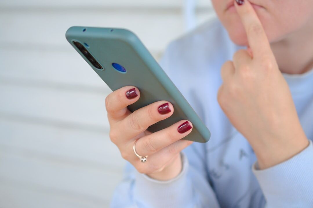 person checking smartphone anxiously